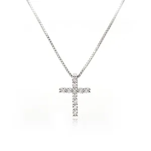 Macro shot of silver cross pendant featuring sparkling cubic zirconia and box chain link