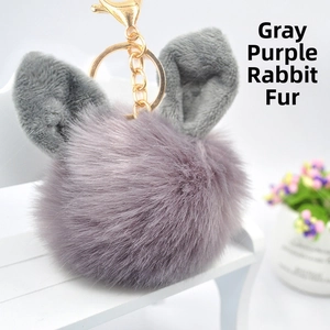 Detail of grey purple faux fur keychain with golden chain and cute rabbit ear design