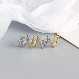 Macro detail of S925 sterling silver triangle hoop earrings with pavé zircon setting