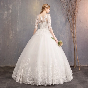 Elegant white ball gown wedding dress with lace embroidery and lace-up back detail