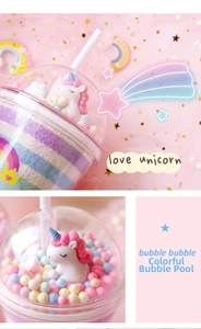 Detail of cute unicorn cup featuring a clear dome lid and colorful macaron foam beads