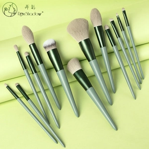 Detail of 12-piece bean green makeup brush set with soft white synthetic bristles