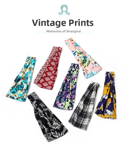 Detailed flat lay of seven vintage-style elastic headbands with various colorful floral patterns