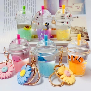 Macro view of assorted mini milk tea cup keychains with floating glitter and cartoon animals