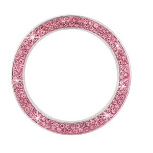 Close-up of sparkling pink crystal car engine start button ring with starburst effect