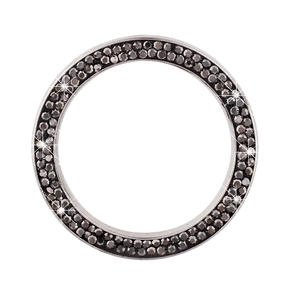 Macro shot of silver car ignition ring with sparkling black rhinestones for car interior