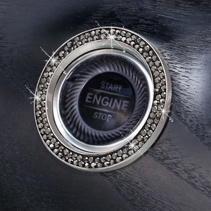 Macro shot of silver car ignition ring with grey crystals on dark wood surface