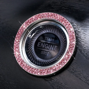 Close-up of a sparkling pink crystal rhinestone car engine start button decorative ring