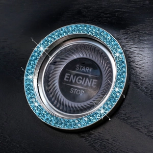 Detail of blue crystal rhinestones on a chrome car engine start stop ignition button ring