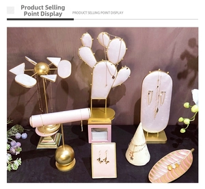 Pink velvet jewelry display set with gold metal frames for earrings and necklaces