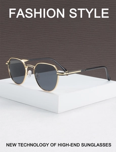 Detail of black hexagonal lenses with golden metal frame and fine hinge craftsmanship