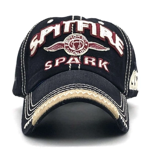 Detail of SPARK embroidered logo and contrast stitching on cotton baseball cap