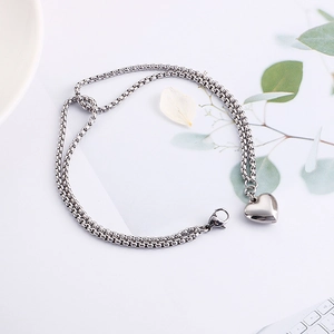 Silver double layer stainless steel chain bracelet with heart pendant on white background