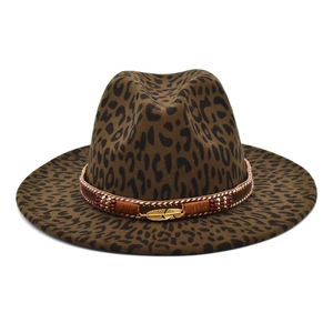 Detail of leopard print fedora hat featuring ethnic beaded band and gold feather charm