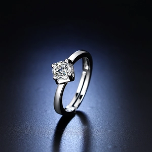 Macro view of four-prong round cut solitaire ring with adjustable open band design