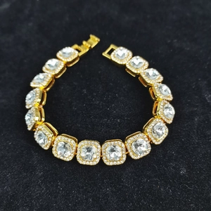 Detailed close-up of hip-hop gold plated bracelet with square iced out zircon stones