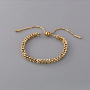 Adjustable gold wheat chain bracelet detail showing center sliding bead and polished finish