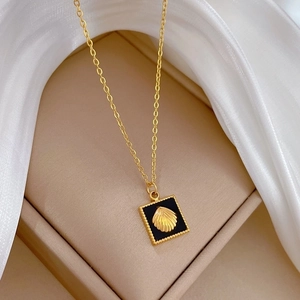 Minimalist gold titanium necklace featuring a black square pendant with a shell motif