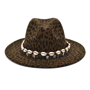 Detail of leopard print wool fedora featuring natural shell band and ethnic woven ribbon