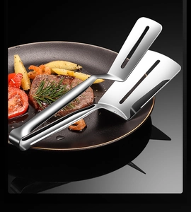 Close-up of 304 stainless steel food tongs picking up steak in a kitchen frying pan