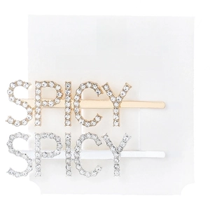 Detail of gold and silver metal hair clips with SPICY rhinestone lettering on a card