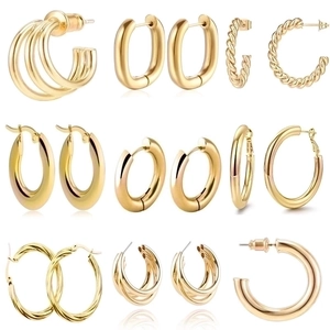 Matrix display of nine pairs of assorted golden punk style earrings on white background