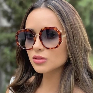 Oversized polygon tortoiseshell sunglasses with dark gradient lenses and gold metal temples