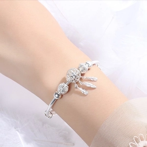 Silver dreamcatcher charm bracelet with feather pendants and adjustable bangle