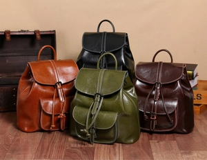 Multiple vintage oil wax leather backpacks in black, brown, green, and dark coffee