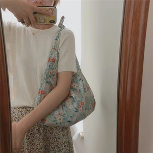 Detailed mirror selfie showing the floral cotton shoulder bag fit and drape