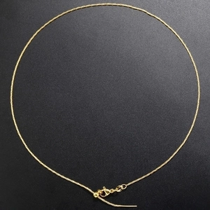 Detail view of gold-plated snake chain necklace with adjustable slider clasp and tail chain