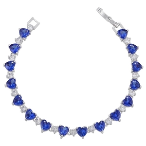 Macro detail of heart-cut blue zircon bracelet with silver-plated chain and secure clasp