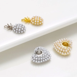 Golden and silver pineapple and heart pendants with pearl accents for DIY jewelry