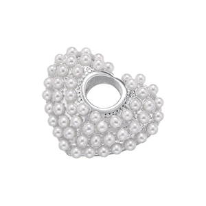 Macro shot of heart-shaped pendant featuring silver plating and lustrous white faux pearls