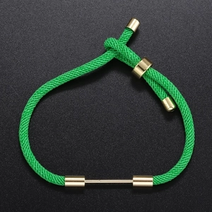 Macro detail of green braided DIY bracelet with adjustable gold metal slide clasp