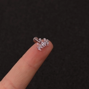 Minimalist silver crown stud earrings with cluster marquise cubic zirconia on a fingertip