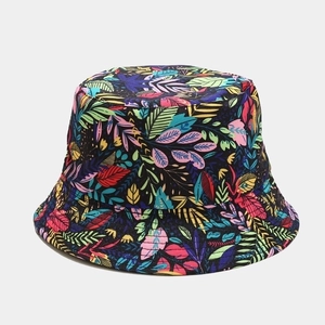 Detail of vibrant tropical leaf pattern on reversible black sun bucket hat fabric