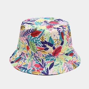 Close-up of tropical leaf print on a reversible sun bucket hat for outdoor activities