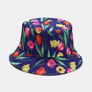 Detail view of the deep purple bucket hat with vibrant floral tulip patterns and green leaves