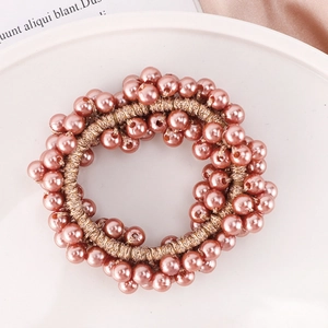 Detailed close-up of pink imitation pearls and elastic cords for elegant hair styling