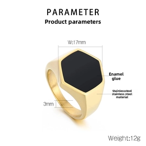 Close-up of golden stainless steel hexagonal signet ring with black enamel inlay and specs
