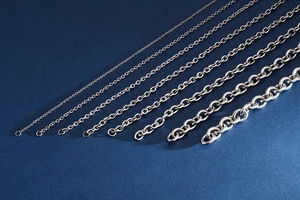 Macro shot showing seven various thicknesses of stainless steel silver link chains for men