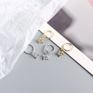 Detailed view of gold and silver S925 sterling silver star hoop earrings with sparkling zircons