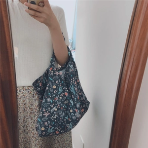 Detail of floral print cotton tote bag showing dark fabric and colorful flower patterns