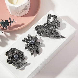 Vintage style brooch set with rhinestones and black pearls in bow and floral designs
