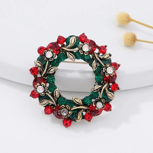 Christmas wreath brooch with red and green crystals on vintage gold alloy leaves