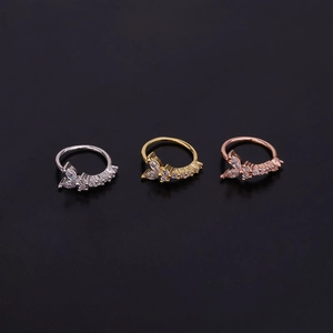 Detailed view of three butterfly cartilage earrings in silver, gold, and rose gold plating