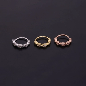 Three zircon-set surgical steel hoop earrings in silver, gold, and rose gold finishes