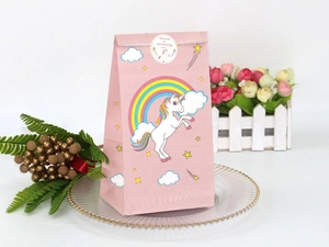 Detailed view of pink unicorn paper gift bag with a round thank you seal sticker