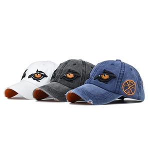 Vintage washed baseball caps featuring embroidered eyes in white, charcoal, and navy colors